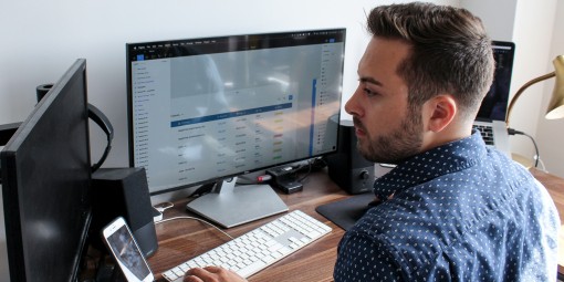 post aquisition man looking as several computer screens